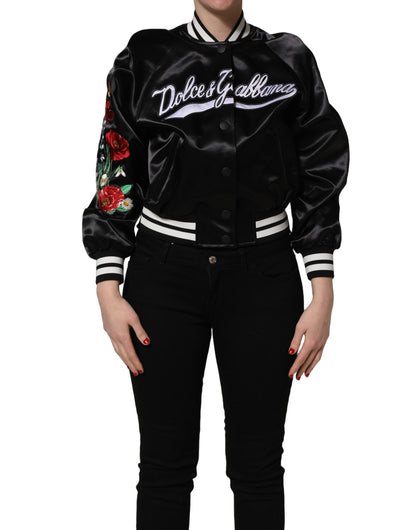 Black satin jacket front view with white striped edges and colorful floral embroidery on the sleeve