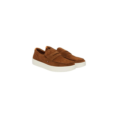 Pair of brown Tommy Hilfiger loafers with light soles, angled front view
