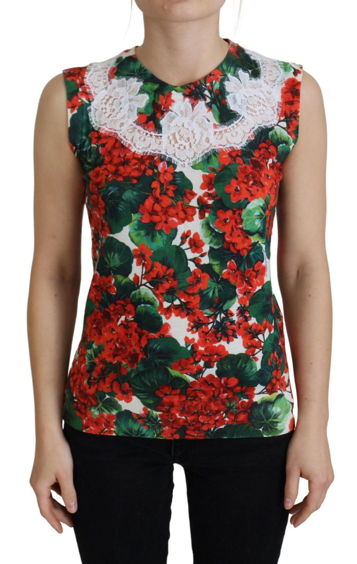 Sleeveless top with red and green floral print and white lace around the neckline viewed from front