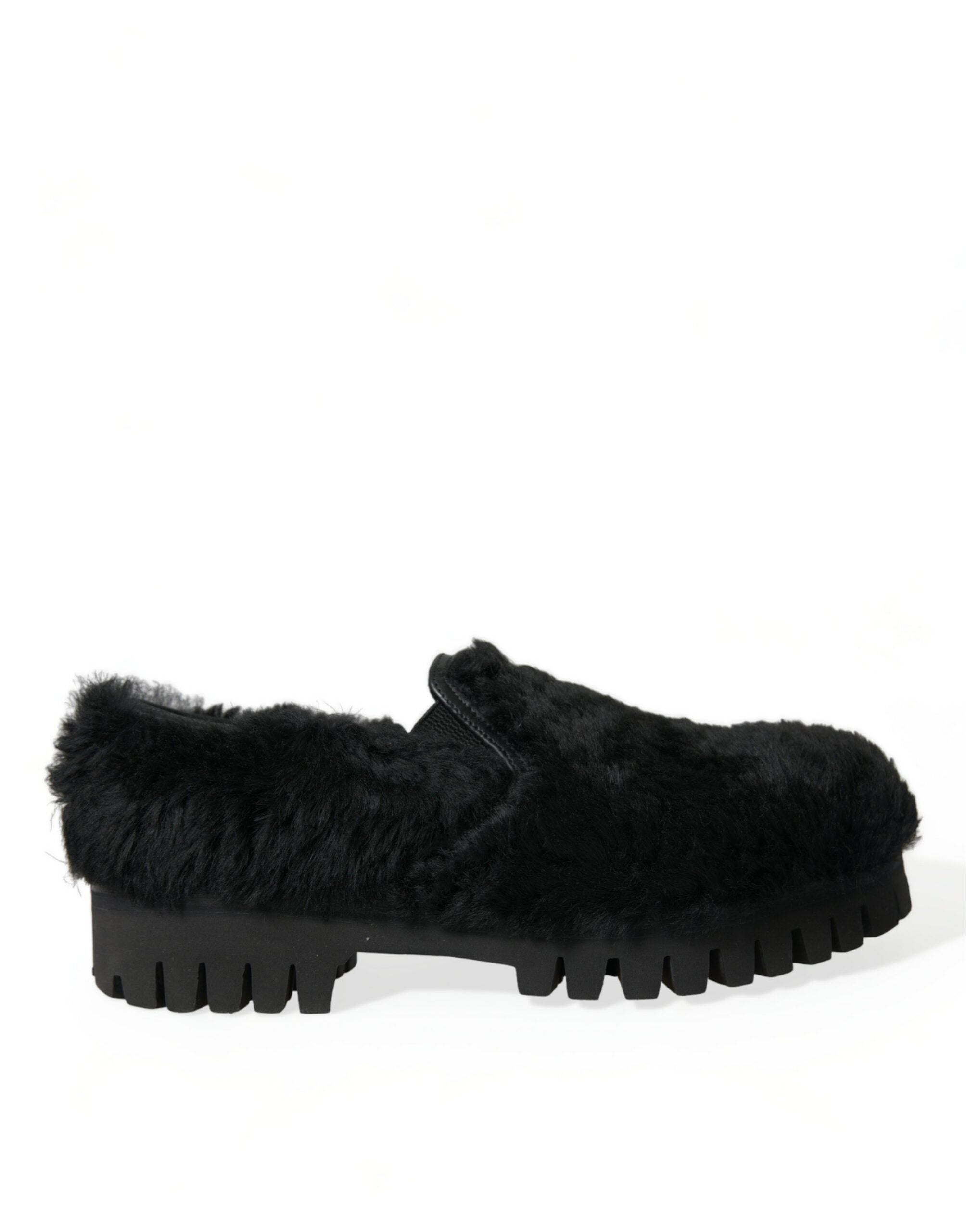 Black shoe with chunky lug sole viewed from the side, covered in soft fur-like material