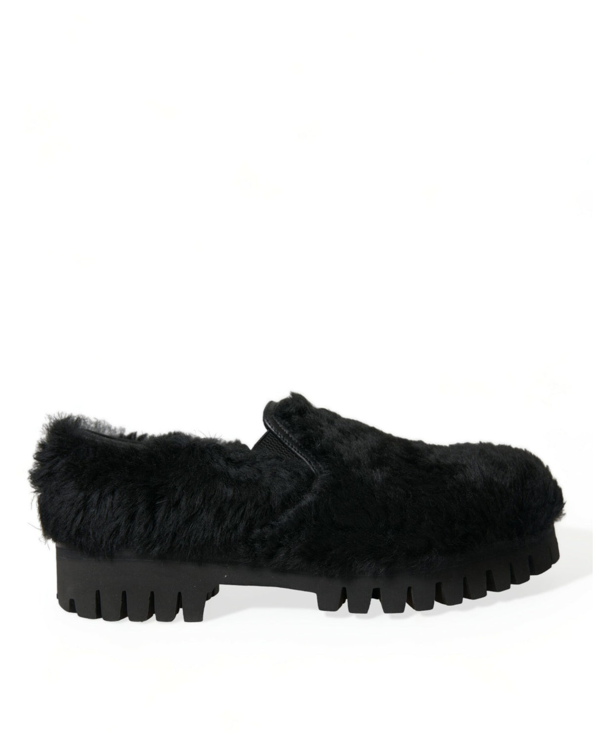 Black shoe with chunky lug sole viewed from the side, covered in soft fur-like material