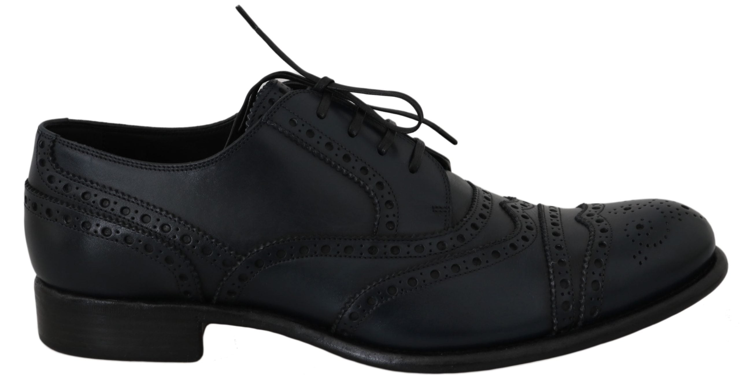 Black lace-up shoe viewed from the side with brogue detailing and low heel