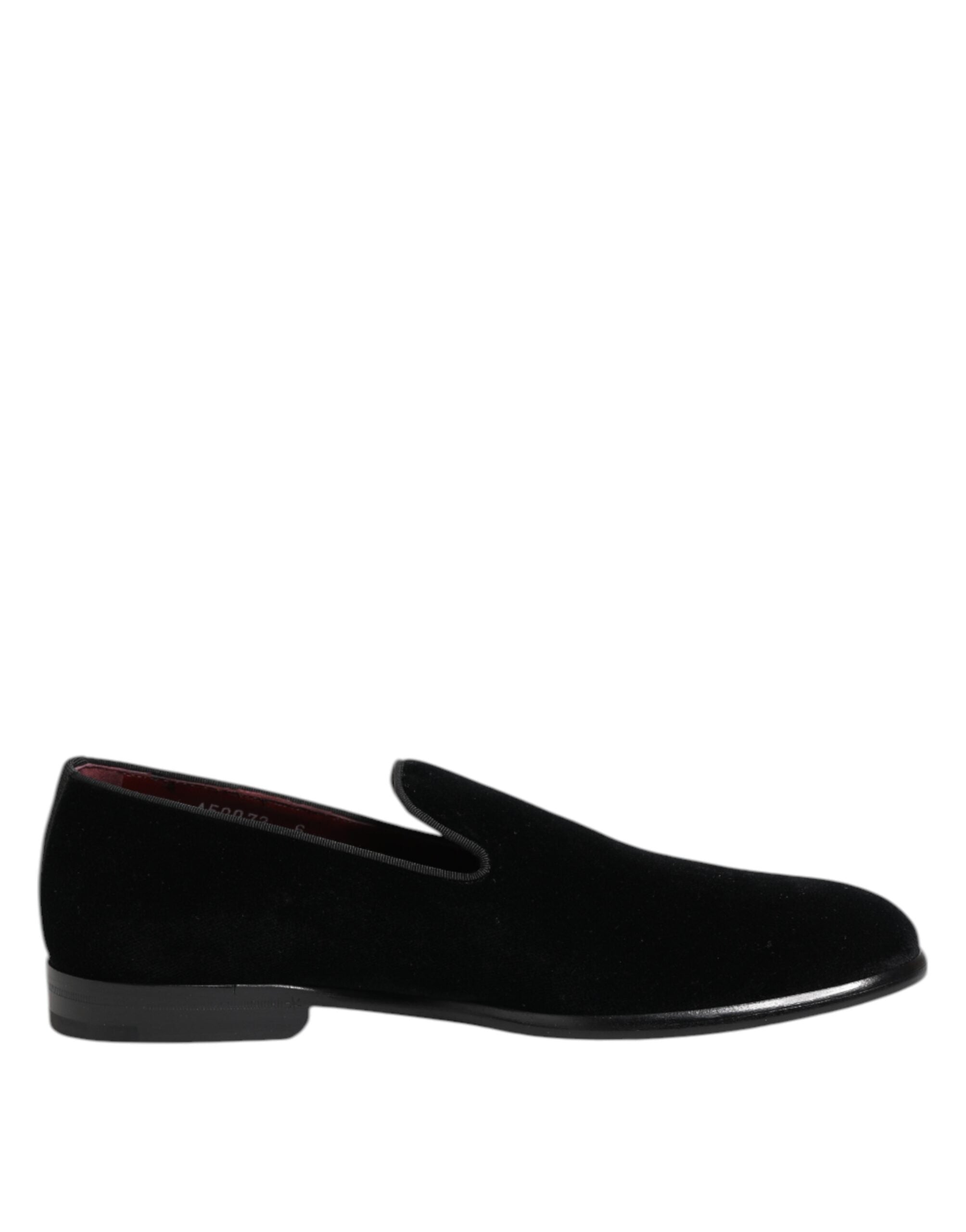 Black slip-on shoe viewed from the side with rounded toe and black sole.