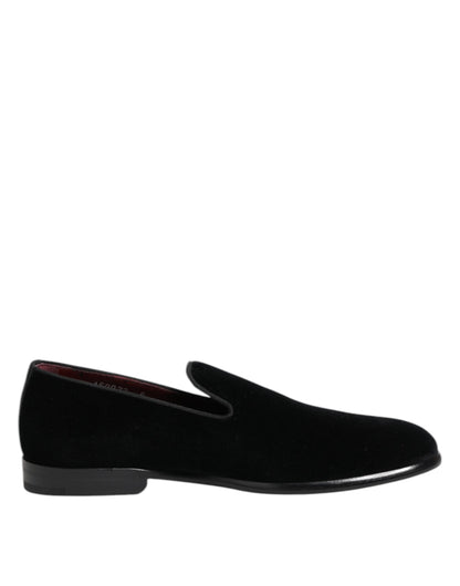 Black slip-on shoe viewed from the side with rounded toe and black sole.