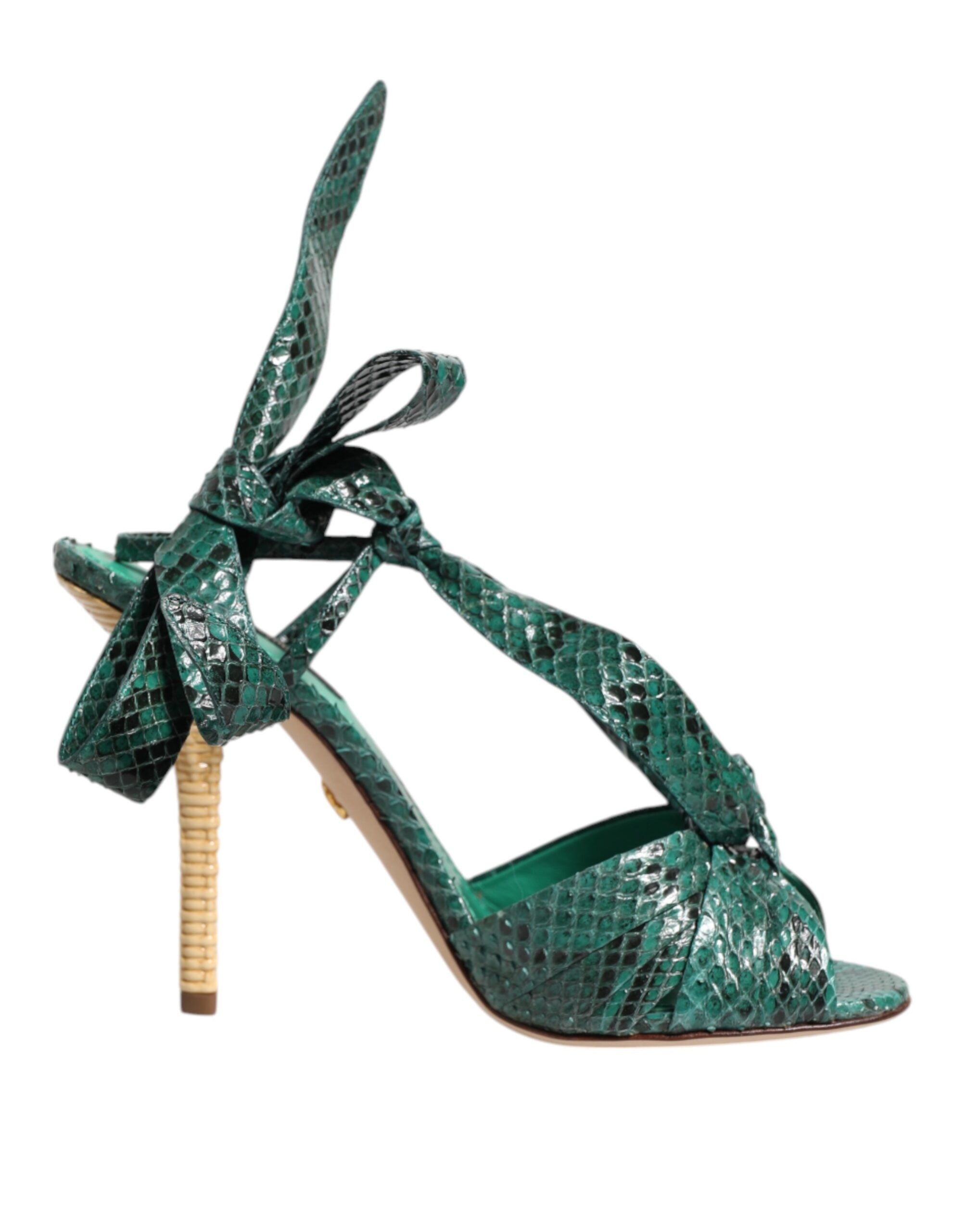 Green sandal with snakeskin texture viewed from the side, featuring high heel and ankle bow details.